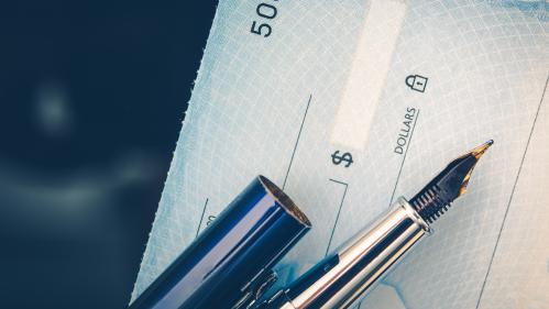 Picture of a bank check and a pen