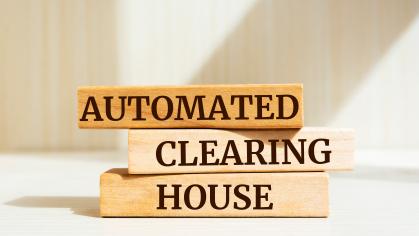 Wooden blocks with words 'Automated Clearing House'.