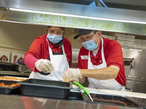 Two employees working at Busch Dining Hall