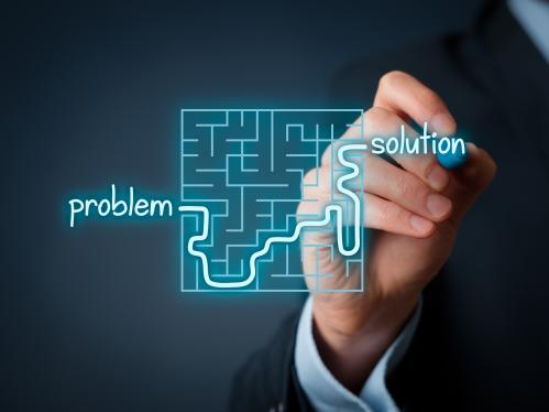 A graphic image of a person tracing a line through a maze, starting at the word problem and exiting the maze at the word solution