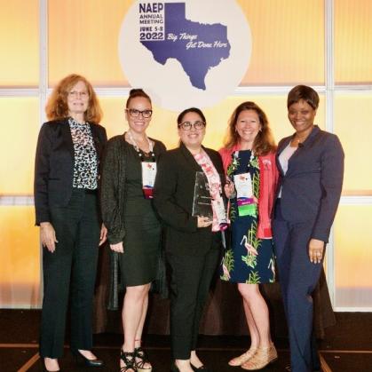 three UPS staff members and two NAEP staff members taking photo with the award